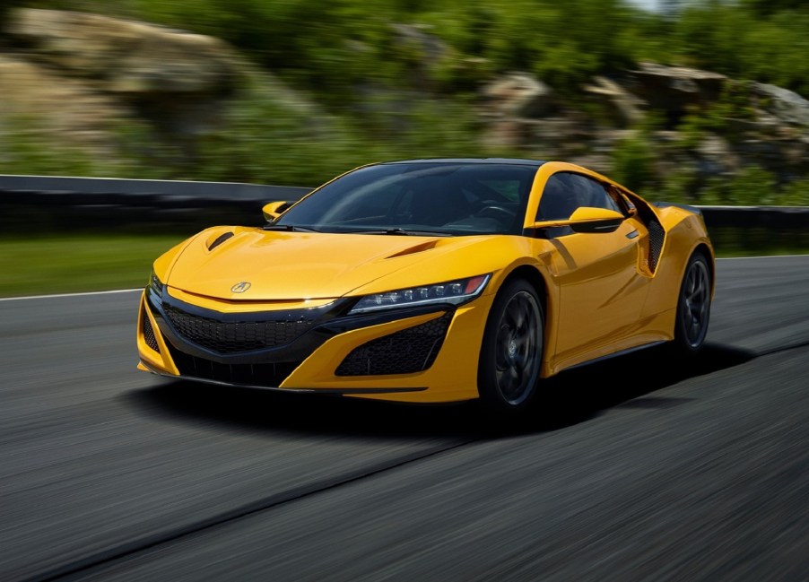 A yellow 2020 Acura NSX drives on a racetrack