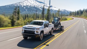 2020 Chevrolet Silverado tows machinery up a mountain road