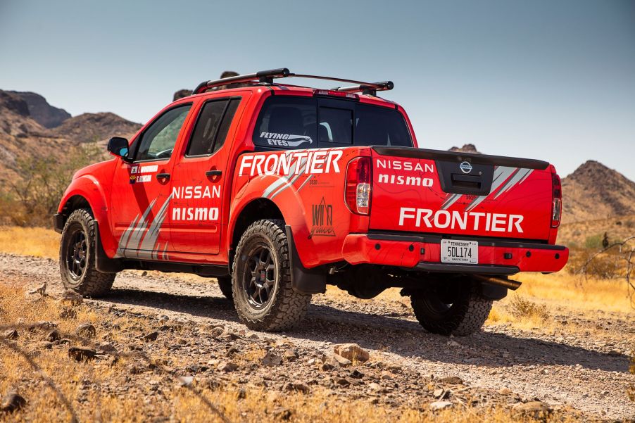 The rear view of a red 2020 Nissan Frontier modified by Nismo for the Rebelle Rally