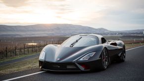 A black 2020 SSC Tuatara on a road with mountains in the background