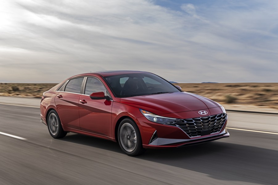 A red 2021 Hyundai Elantra driving on a highway