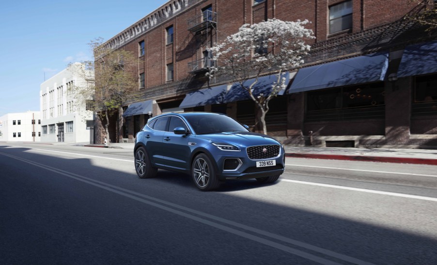 A blue 2021 Jaguar E-Pace driving down a city street