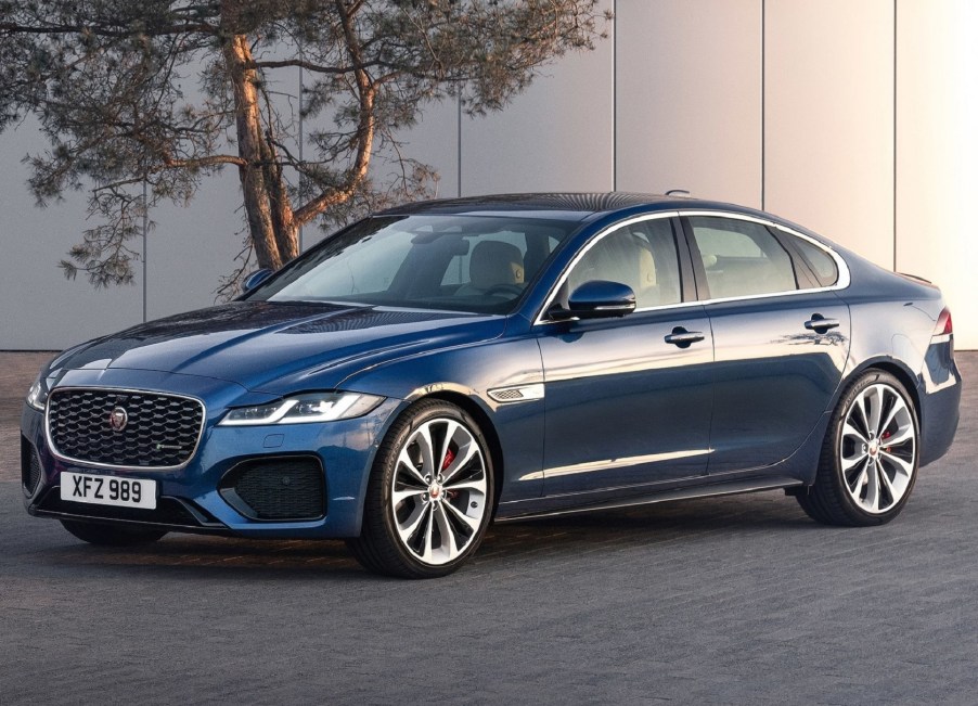 A blue 2021 Jaguar XF in front of a white building