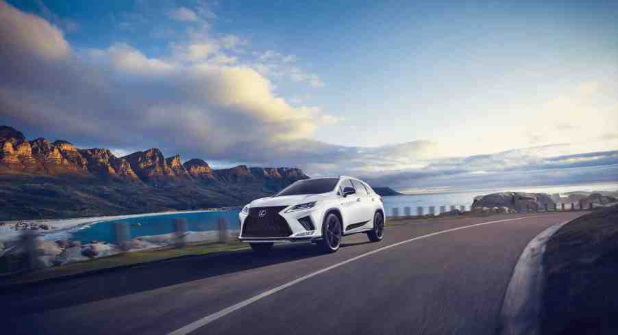 A 2021 Lexus RX with Black Line trim drives down a coastal road