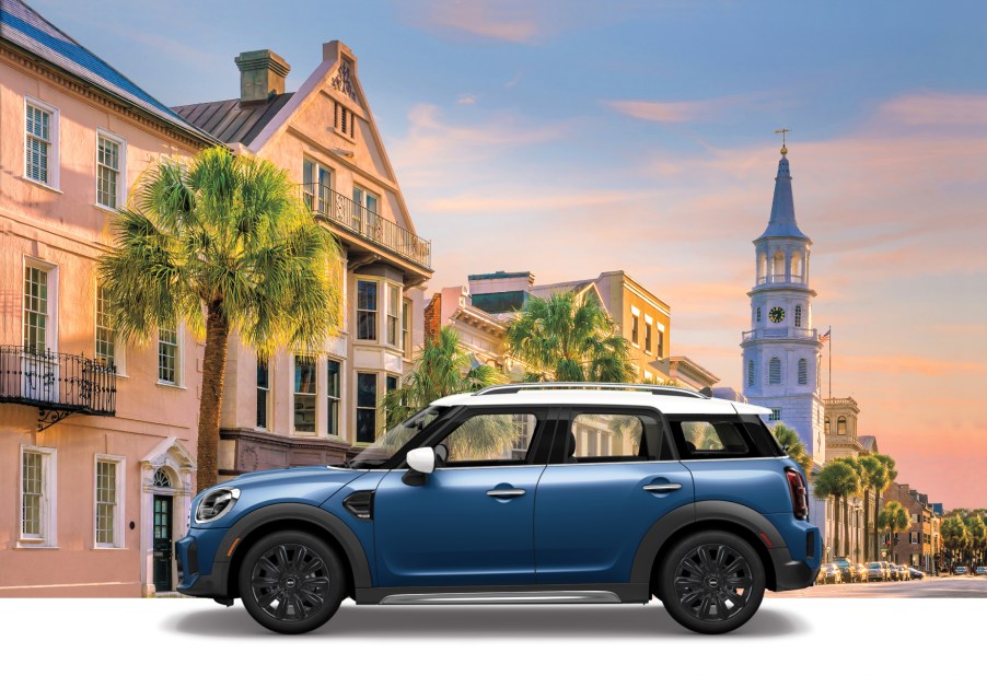 A blue 2021 Mini Countryman Oxford Edition on display with British scenery in the background.