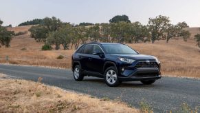 A 2021 Toyota RAV4 Hybrid XLE driving down a road