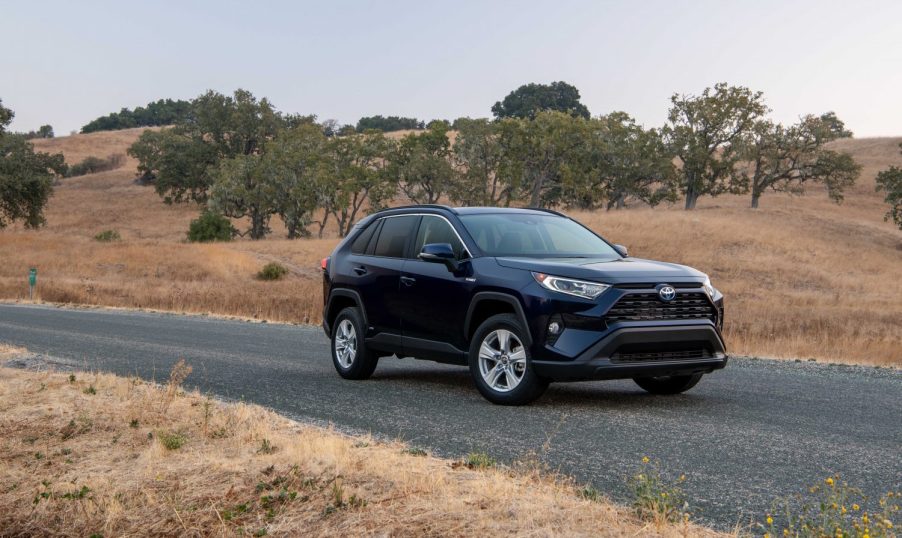 A 2021 Toyota RAV4 Hybrid XLE driving down a road