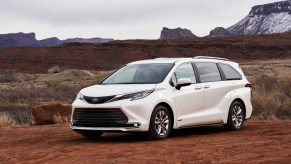 A white 2021 Toyota Sienna on display in a desert terrain