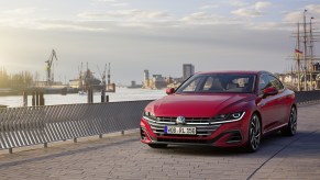 A red 2021 Volkswagen Arteon driving down a street