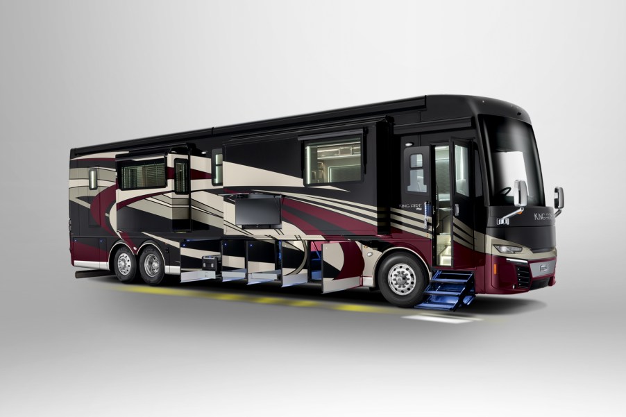 A Newmar Corp King Aire RV has all its storage compartment door open on the bottom of the bus.