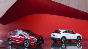 Two 2022 Mitsubishi Eclipse Cross SUVs on display, one facing toward the camera and the other facing away