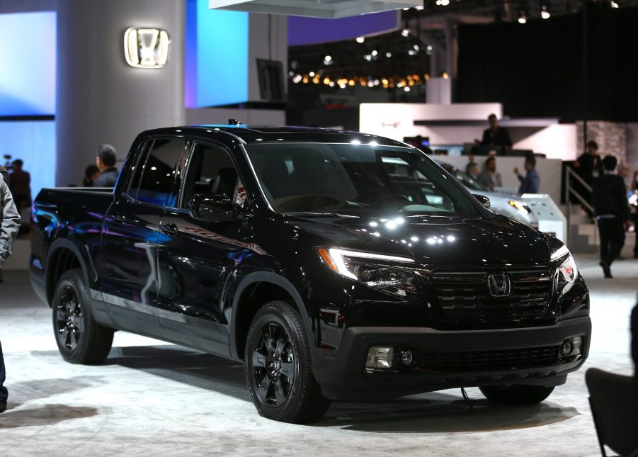 A black Honda Ridgeline on display at an auto show