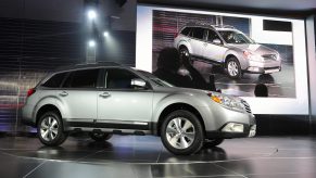 A Subaru Outback on display at an auto show.