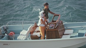 A man and woman take their Boston Whaler boat out to sea at Lyford Cay, Bahamas