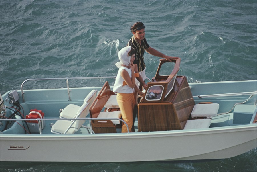 A man and woman take their Boston Whaler boat out to sea at Lyford Cay, Bahamas