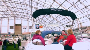 A family sitting in a boat at a display