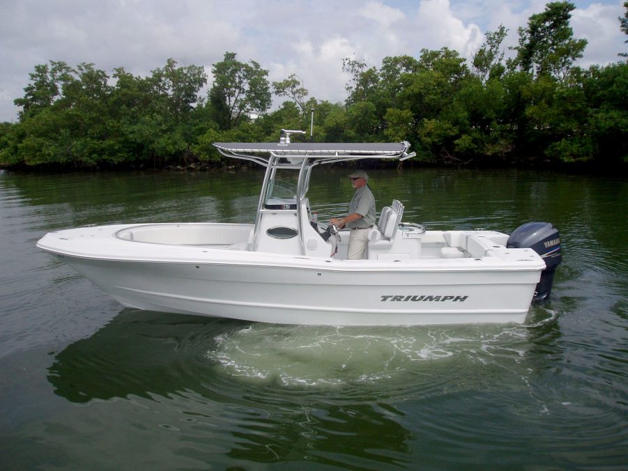 A center console boat riding in a creek