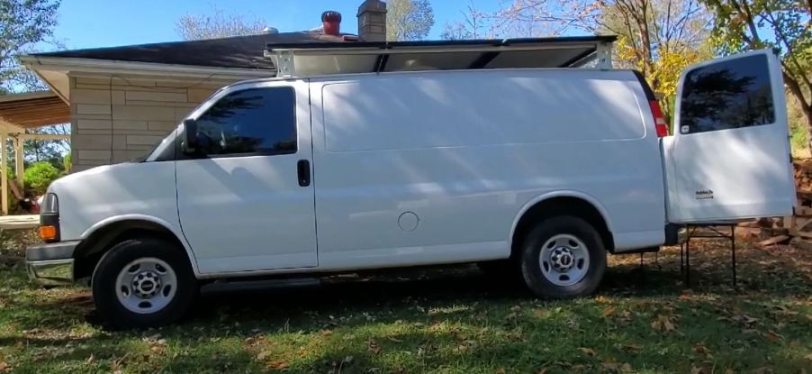 A white full-size van that has been converted into an RV.