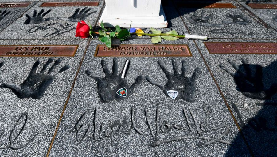 Momentoes including a rose, guitar picks and a cigarette are left on the handprints at the Guitar Center in Hollywood, California of rock guitarist Eddie Van Halen on October 6, 2020. - Van Halen placed his hands in the cement and was inducted into the Hollywood, California RockWalk on November 13, 1985. Eddie Van Halen, the guitar virtuoso whose group is considered one of the greatest rock bands of all time, died on October 6, 2020 following a long battle with cancer, his son announced. (Photo by Frederic J. BROWN / AFP) (Photo by FREDERIC J. BROWN/AFP via Getty Images)