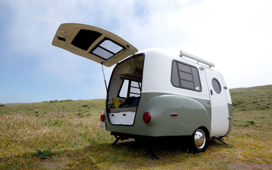 The exterior of a green and white HC1 trailer .