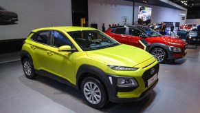 A green Hyundai Kona on display at an auto show