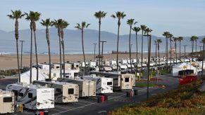 RVs parked at a lot by the ocean