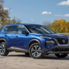 A blue 2021 Nissan Rogue parked on the track.