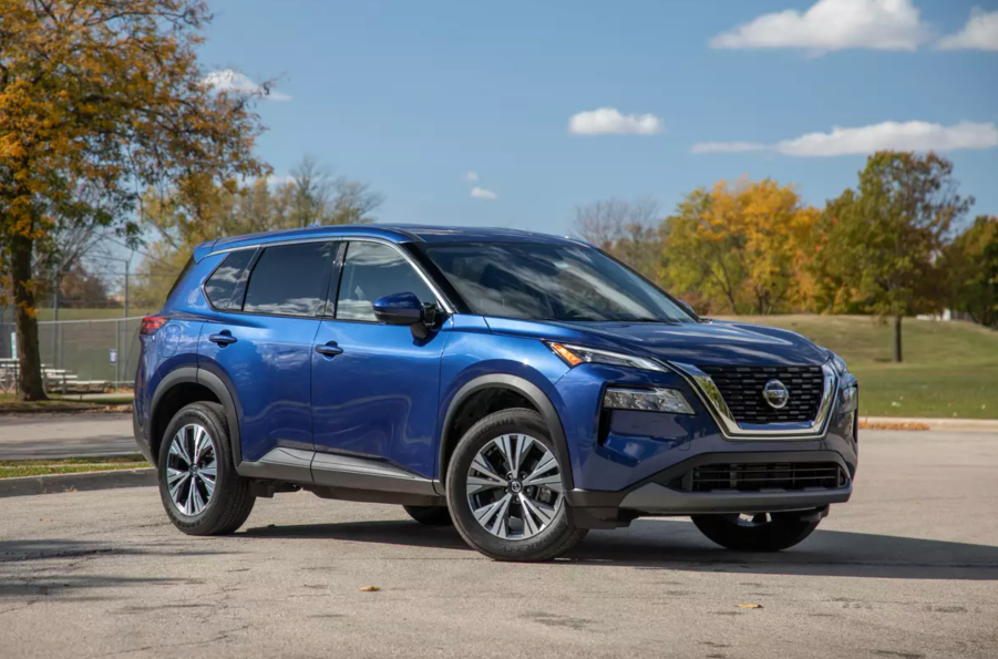 A blue 2021 Nissan Rogue parked on the track.