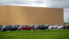 GMC and Chevrolet pickup trucks sit in a parking lot outside the GM Fort Wayne Assembly Plant