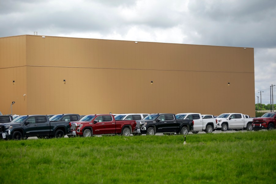 GMC and Chevrolet pickup trucks sit in a parking lot outside the GM Fort Wayne Assembly Plant