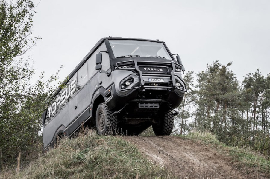 A gray Torsus Praetorian climbs an off-road hill