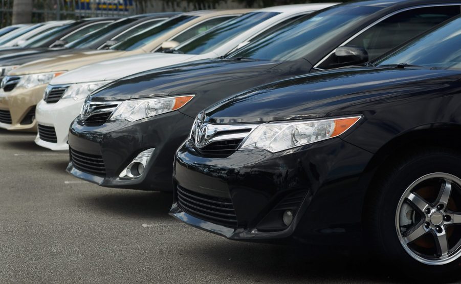 Toyota Camrys on display at a car dealership lot