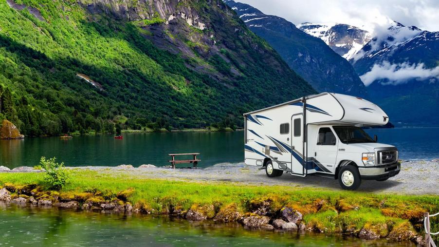 A white Winnebago Outlook with dark accents. on the countryside.