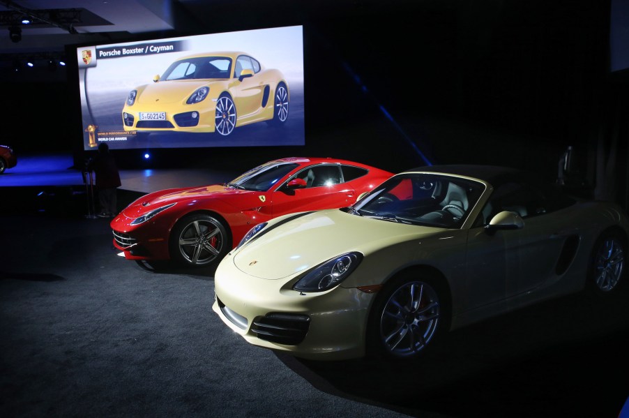 A Porsche Boxster/Cayman (R) sits on display after being named the 2013 World Performance Car of the Year at the New York Auto Show on March 28, 2013, in New York City.