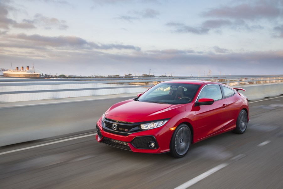 red 2017 Honda Civic sedan driving on highway bridge