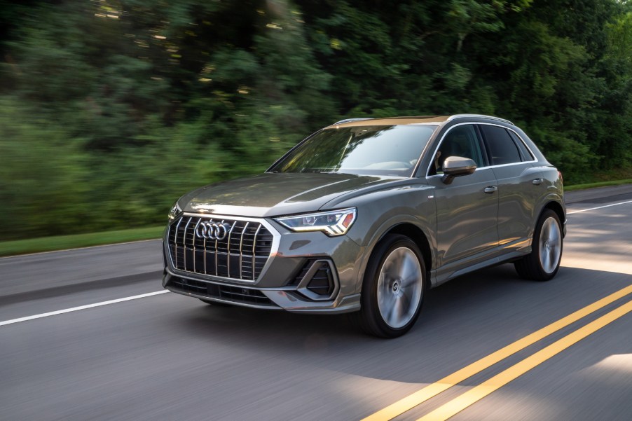 A silver 2021 Audi Q3 driving down a highway street