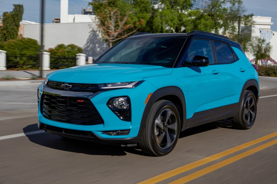 A blue 2021 Chevy Trailblazer driving down a city street