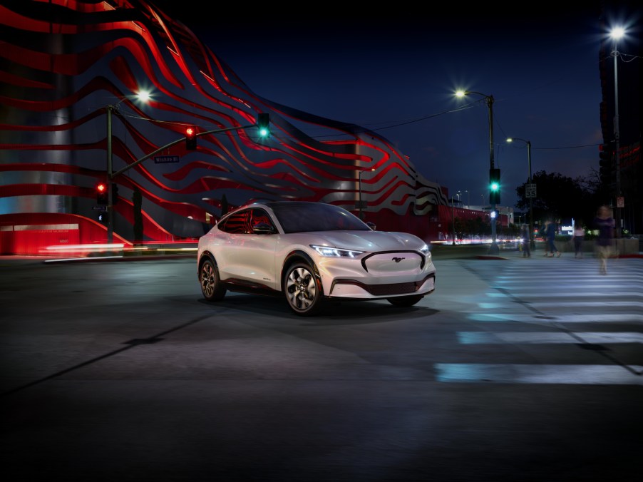 A white 2021 Ford Mustang Mach-E parked on a city street