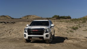 A 2021 GMC Yukon AT4 driving on sandy terrain