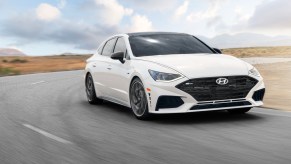 A white 2021 Hyundai Sonata N Line driving on a road