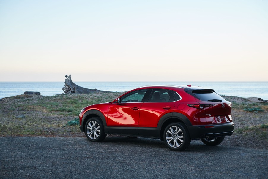 A red 2021 Mazda CX-30 parked near the ocean