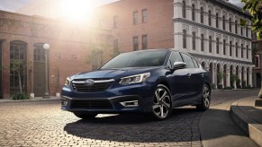 A blue 2021 Subaru Legacy parked in a city