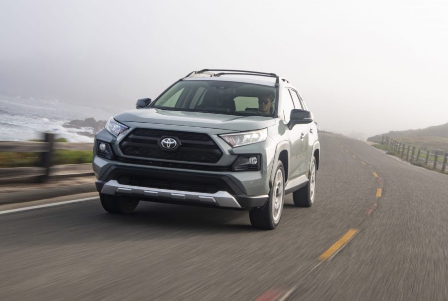 A silver 2021 Toyota RAV4 driving on a highway road