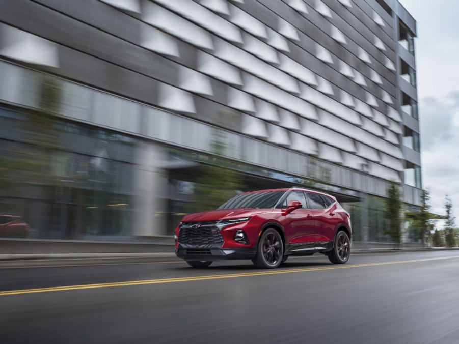 2021 red Chevy Blazer on road near large office building