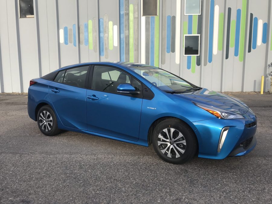 An electric blue 2021 Toyota Prius parked on the street.