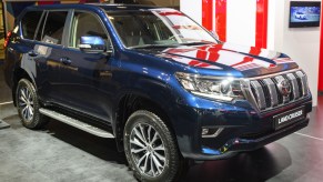 A Toyota Land Cruiser on display at an auto show