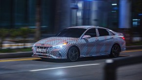 A camouflaged 2021 Hyundai Elantra N driving down a city street