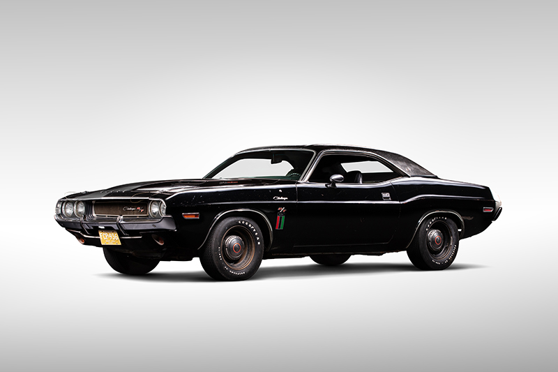 A photo of a 1970 Dodge Challenger in a photo studio.