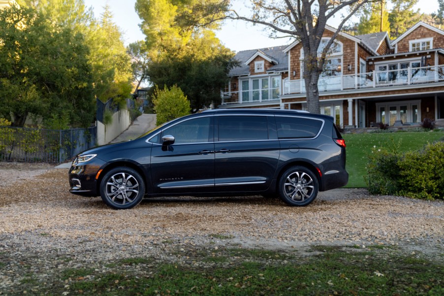 A black 2021 Chrysler Pacifica parked in front of a house