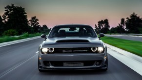 A photo of the 2018 Dodge Challenger SRT Demon driving through a city.